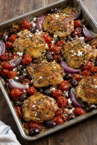 Easy Mediterranean Dinner Recipes Under 500 Calories: sheet pan chicken thighs with cherry tomatoes, red onion, kalamata olives and feta