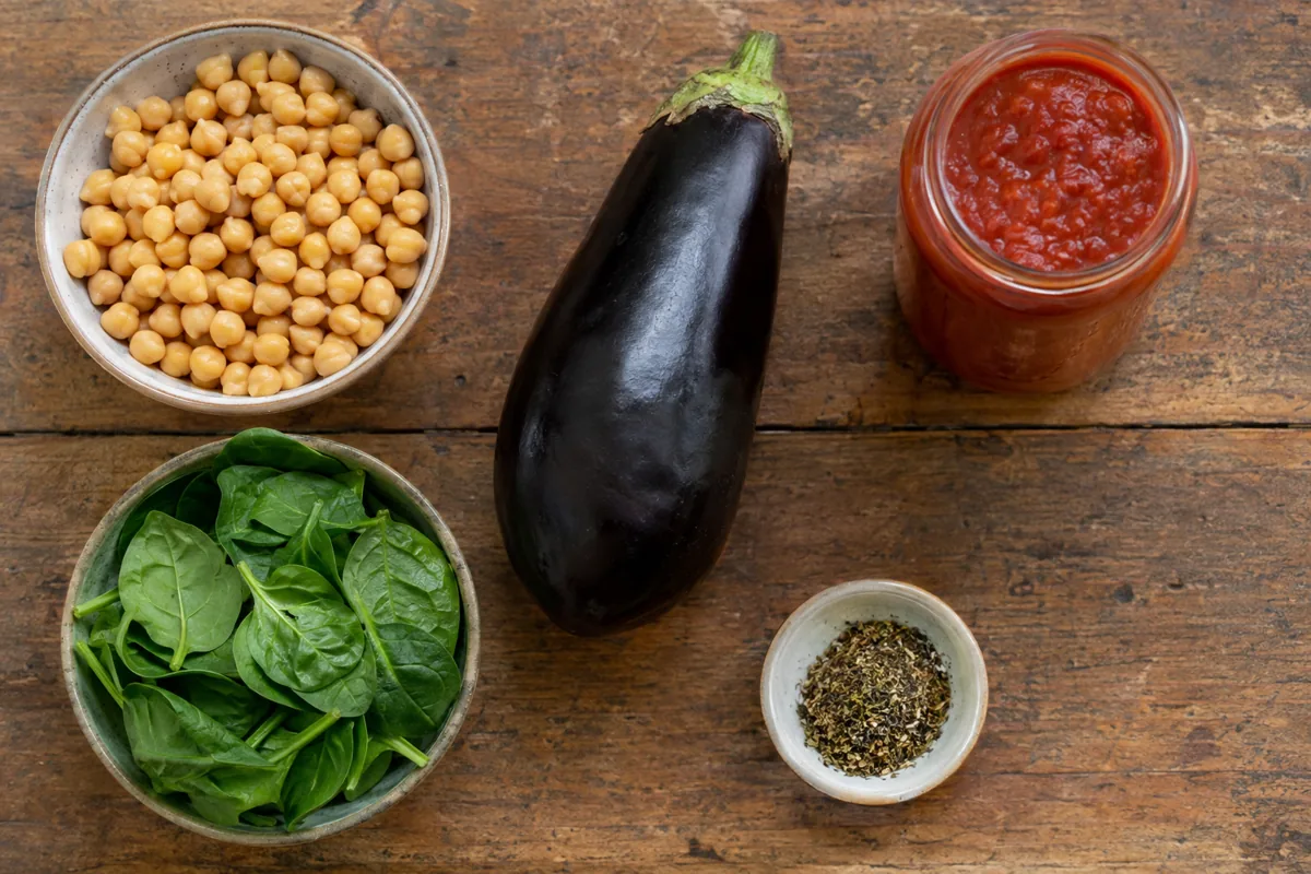 Ingredients laid out: chickpeas, eggplant, marinara sauce, spinach and Italian seasoning